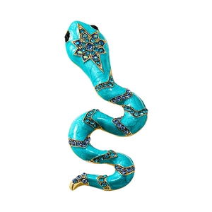 Macro shot of blue enamel snake brooch with sparkling crystals and star-shaped head detail