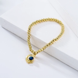 Goldenes Perlenarmband mit kreativem Astronautenanhänger und blauem Sternstein-Charme