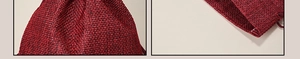 Close-up of dark red burlap drawstring pouch showing coarse texture and rope detail