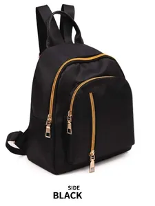 Side view of a minimalist black waterproof nylon women backpack with gold zippers