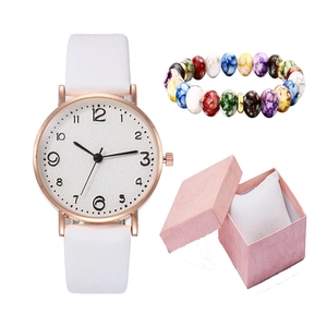 Golden quartz watch with white strap and colorful beaded bracelet in a pink gift box