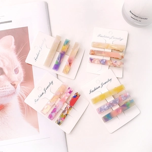 Set of three colorful acetate resin hair clips with marble patterns and metal clasps