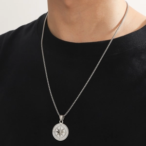 Men's silver stainless steel compass pendant necklace featuring NESW engraving on a round disc