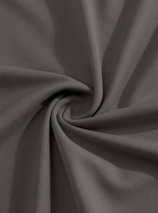Macro shot of dark grey knit fabric texture showing fine weave and premium drape quality