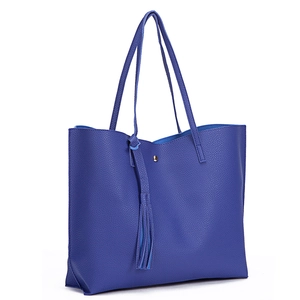 Close-up of blue lychee grain PU leather tote bag with stylish tassel decoration detail