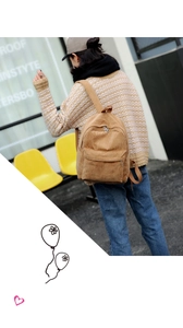 Corduroy backpack for women in khaki, shown on a model against a street window background