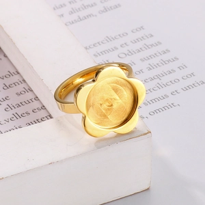 Minimalist 18K gold plated stainless steel flower ring displayed on a white decorative base