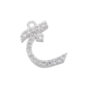 Detailed macro shot of silver Arabic letter pendant with sparkling cubic zirconia stones
