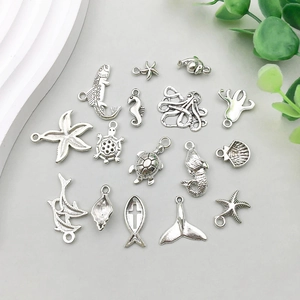 Detailed set of silver ocean charms featuring starfish, mermaid, and turtle pendants
