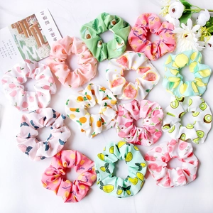 Flat lay of colorful fruit pattern scrunchies with strawberry and avocado designs