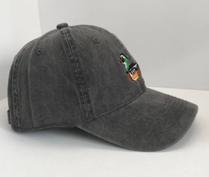 Detail of pixel duck embroidery on vintage washed cotton baseball cap in charcoal gray
