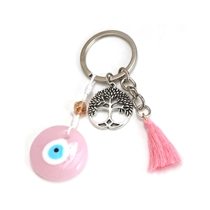 Macro detail of pink Evil Eye bead with silver Tree of Life charm and silk tassel