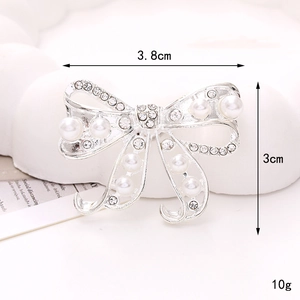 Macro detail of silver bow shoe charm with pearls and rhinestones 3.8cm wide