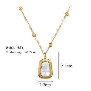 Close-up of gold shell pendant with dimensions and chain length specifications