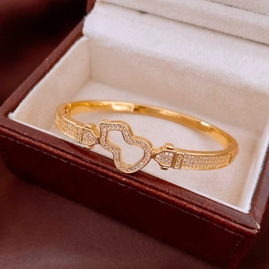Detail of 18K gold plated gourd bracelet with hollow design and inlaid zircon stones