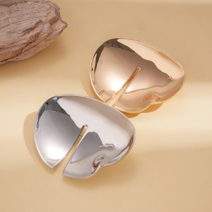Exaggerated irregular round geometric brooch in polished gold and silver metal finishes