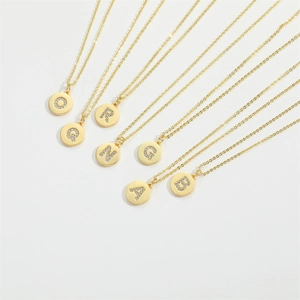 Minimalist gold necklaces with zircon initial letter pendants on a white background