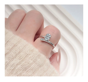 Macro shot of s925 silver ring featuring an oval-cut diamond and wrap-around band design