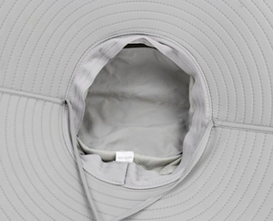 Detail view of wide brim sun hat showing mesh lining and adjustable chin strap
