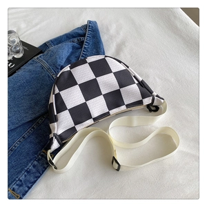 Close-up of hip-hop checkerboard crossbody bag with adjustable strap and fashion magazine