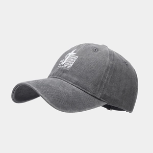 Detail showing washed gray cotton texture and white cross print on baseball cap