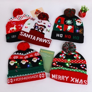 Detailed macro view of festive LED knitted hats with colorful lights and pom-poms