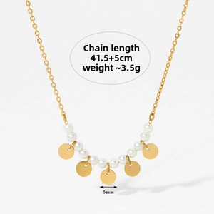 Detail of minimalist stainless steel necklace with white pearls and 5mm gold discs