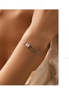 Detail of S925 sterling silver double-layer bracelet with square zircon on female wrist