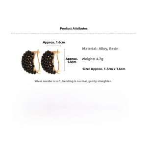 Detail view of black resin bead hoop earrings with 1.8cm by 1.6cm dimensions