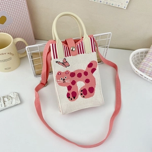 Close-up of pink knit crossbody bag featuring cute leopard cat and butterfly patterns