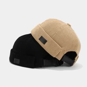Retro corduroy docker hats in black and khaki with adjustable leather back straps