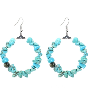 Detail of bohemian hoop earrings with light blue irregular stones and silver hooks