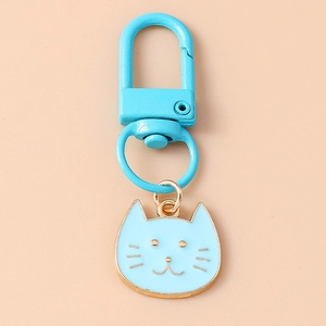Detail of light blue cartoon cat keychain with golden edges and lobster clasp