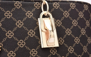 Detailed close-up of premium PU leather texture and gold-tone metal hardware of women handbag