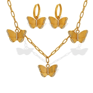 Elegant gold butterfly jewelry set with zircon necklace and earrings on white background