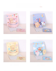 Detailed close-up showing four 3D pop-up birthday cards with cute bear and cake designs