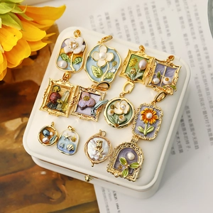 Detail of vintage enamel floral pendants with gold frames and baroque pearls
