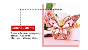 Macro detail of butterfly keychain with pink crystals and rhinestones on gold base