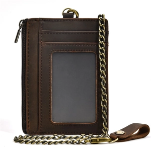 Detail view of vintage brown leather coin purse with zipper and metal key chain