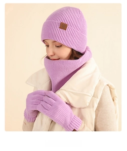 Detail of purple winter knit set with thick ribbed texture on hat, scarf and gloves