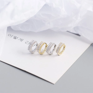 Detail of S925 sterling silver hoop earrings with rectangular zircon in gold and silver