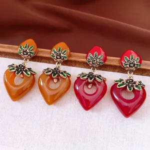 Vintage heart shaped earrings with amber and burgundy enamel and rose gold details