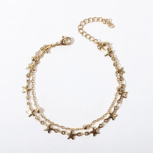Close-up of a double-layer gold chain bracelet with star charms and adjustable clasp