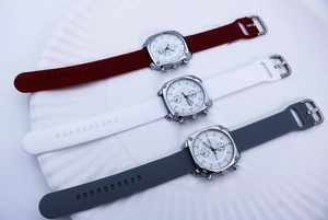 Detailed macro of Ermido square quartz watches with colorful silicone straps on white tray