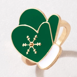 Macro view of Christmas glove ring with snowflake detail and green enamel finish