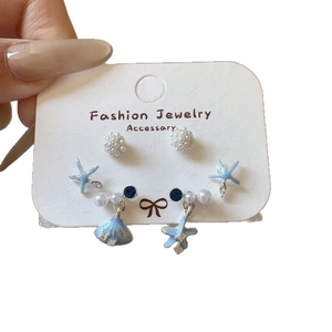 Three pairs of marine style silver stud earrings with shell, starfish and pearls