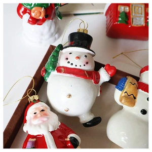 Detailed view of festive snowman and Santa figurines with golden hanging cords