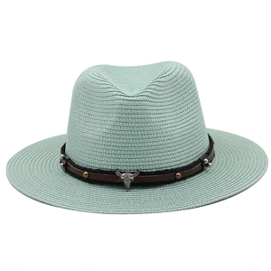 Mint green woven straw fedora hat with a leather strap and vintage silver ox skull emblem