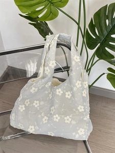 Light blue mesh tote bag with white 3D flower embroidery and wide shoulder straps
