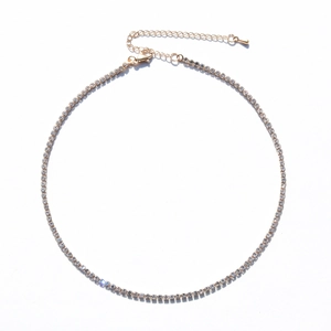 Close-up of gold-plated tennis necklace with lobster clasp and adjustable extension chain